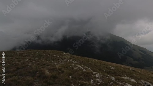 Clouds moving on top of the mountain in National park Galicica photo