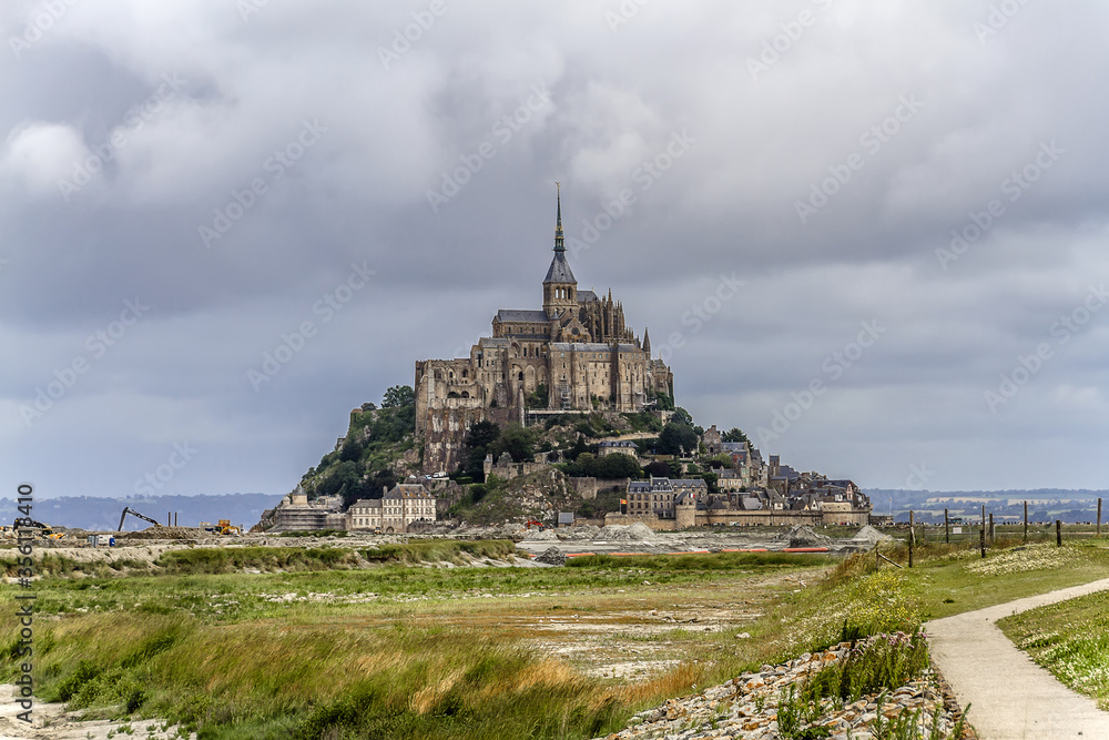 Abbey Mont Saint-Michel (VII century) at rocky tidal island in Normandy - one of most visited tourist sites in France. Normandy, Northern France, Europe.