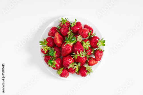 Strawberries. Juicy strawberries in plate on white background. Flat lay, top view, copy space