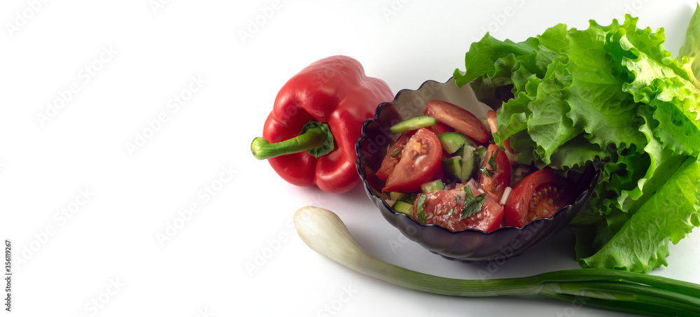 Plate with chopped spring vegetables, onions, red peppers and green salad on a white background Plate with chopped spring vegetables, onions, red peppers and green salad on a white background