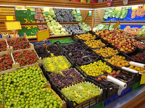 Greengrocer. Fresh vegetables and fruits. Pineapple, strawberries, potatoes, eggplant, lemon, watermelon.