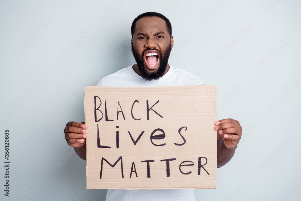 Photo of displeased crazy yell dark skin african protester hold placard against black citizens civil social lawlessness stop murder black people human concept isolated grey color background Photo of displeased crazy yell dark skin african protester hold placard against black citizens civil social lawlessness stop murder black people human concept isolated grey color background