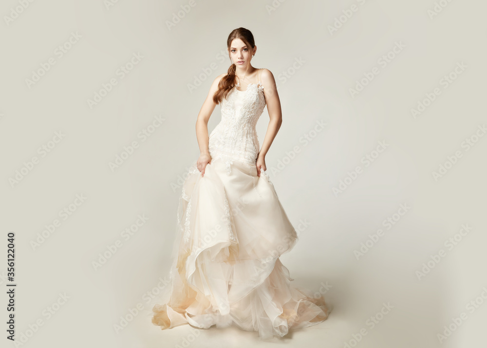 Fototapeta premium girl in a nude dress with tulle with lace on a white background