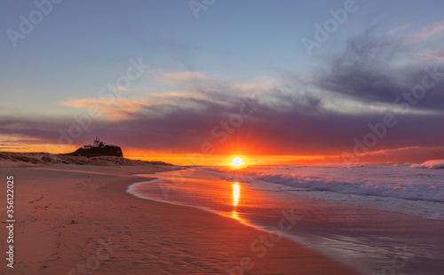 Beautiful winter's sunrise over Nobbys Beach and Lighthouse. Newcastle, east coast of N.S.W. of Australia.