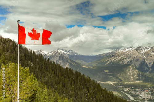 National flag of Canada, the Maple Leaf, flying on the lookout point on the top of Sulphur Mountain in Banff.