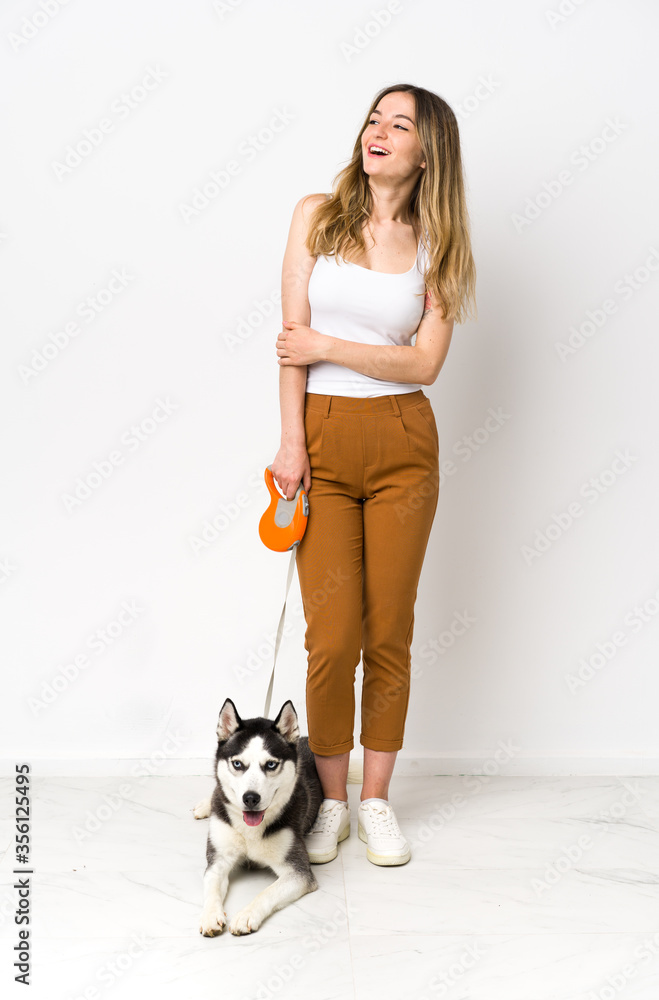 A full length young pretty woman with her dog happy and smiling A full length young pretty woman with her dog happy and smiling