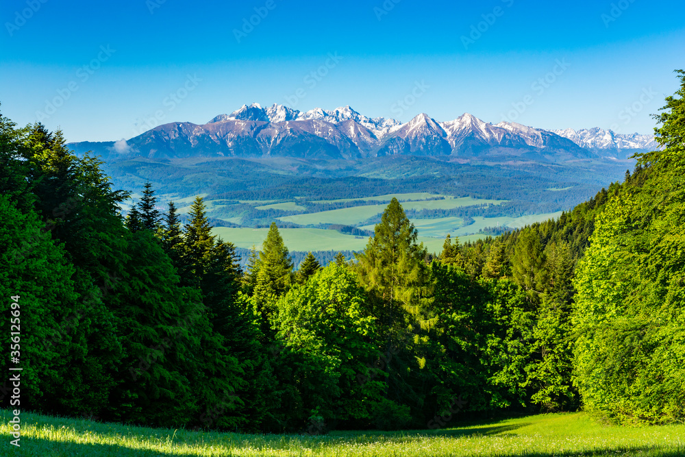 Beautiful spring view of the mountains. The highest peaks and slopes are still covered with snow.
