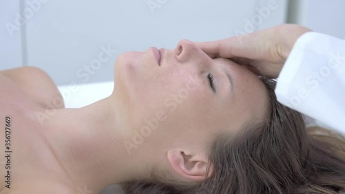 Close-up 4K video of woman enjoying japanese face massage in professional salon