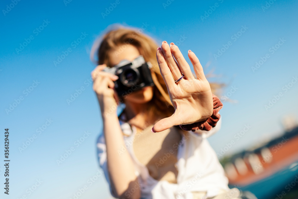 Happy young tourist smiling with sunglasses and camera