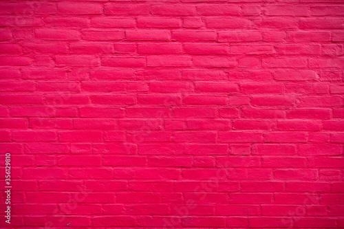 Saturated pink brickwall Background with cement texture