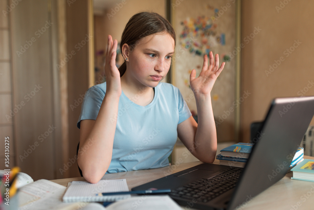 Teenager girl, surprised upset, misunderstanding embarrassment and indignation, home lessons with laptop, video training on Internet. Bad rating and internet error. Bad exam and social media conflict. Teenager girl, surprised upset, misunderstanding embarrassment and indignation, home lessons with laptop, video training on Internet. Bad rating and internet error. Bad exam and social media conflict.