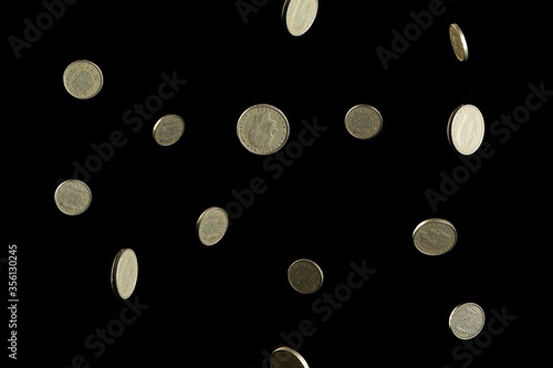 Old Spanish coins, pesetas, on black background.
