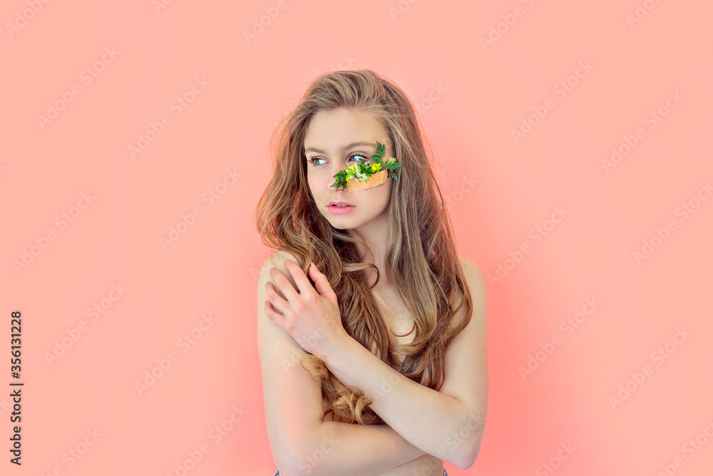 Portrait attractive brunette girl with green branch on face with mock up Portrait attractive brunette girl with green branch on face with mock up