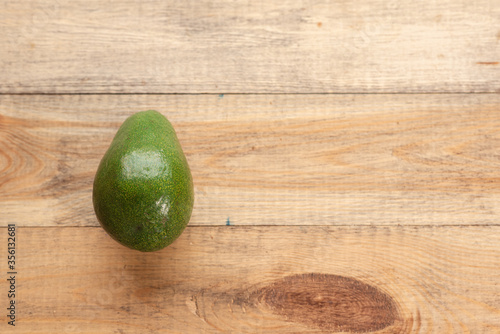 Juicy and tasty avocado on a wooden table. Healthy food