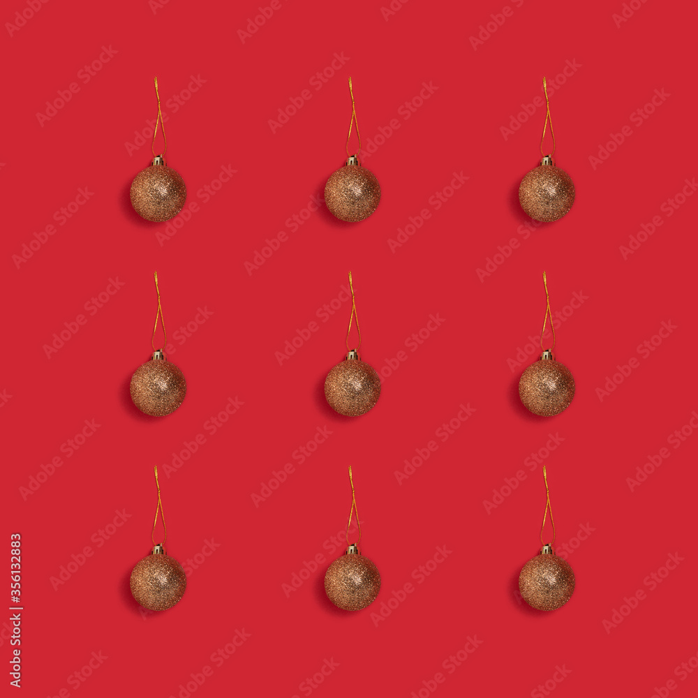 Layout of golden glittering Christmas balls on a red background. Holidays concept. Layout of golden glittering Christmas balls on a red background. Holidays concept.