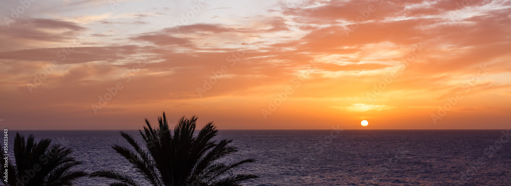 A sunset over a body of water A sunset over a body of water