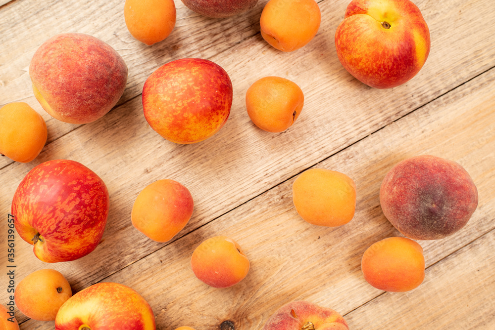 Large ripe and juicy peaches, apricots and nectarines on a wooden table. Healthy diet Large ripe and juicy peaches, apricots and nectarines on a wooden table. Healthy diet