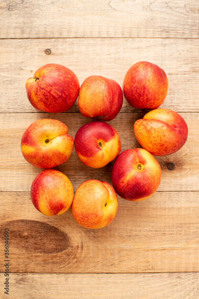 Large ripe and juicy nectarines on a wooden table. Healthy diet Large ripe and juicy nectarines on a wooden table. Healthy diet