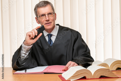Leinwand Poster Judge or lawyer dictating a judgement or a brief