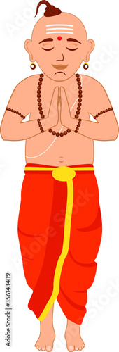 Indian priest in traditional Indian clothing with folded hands and praying.