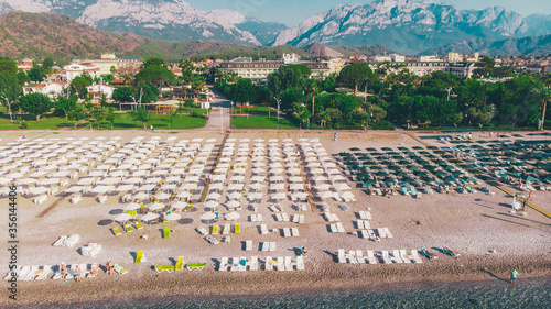 Holiday vacation on the sandy beach, sunbathing i swimming in the water aerial drone photo