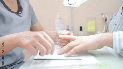 a manicurist saws a man's nails. High quality FullHD footage