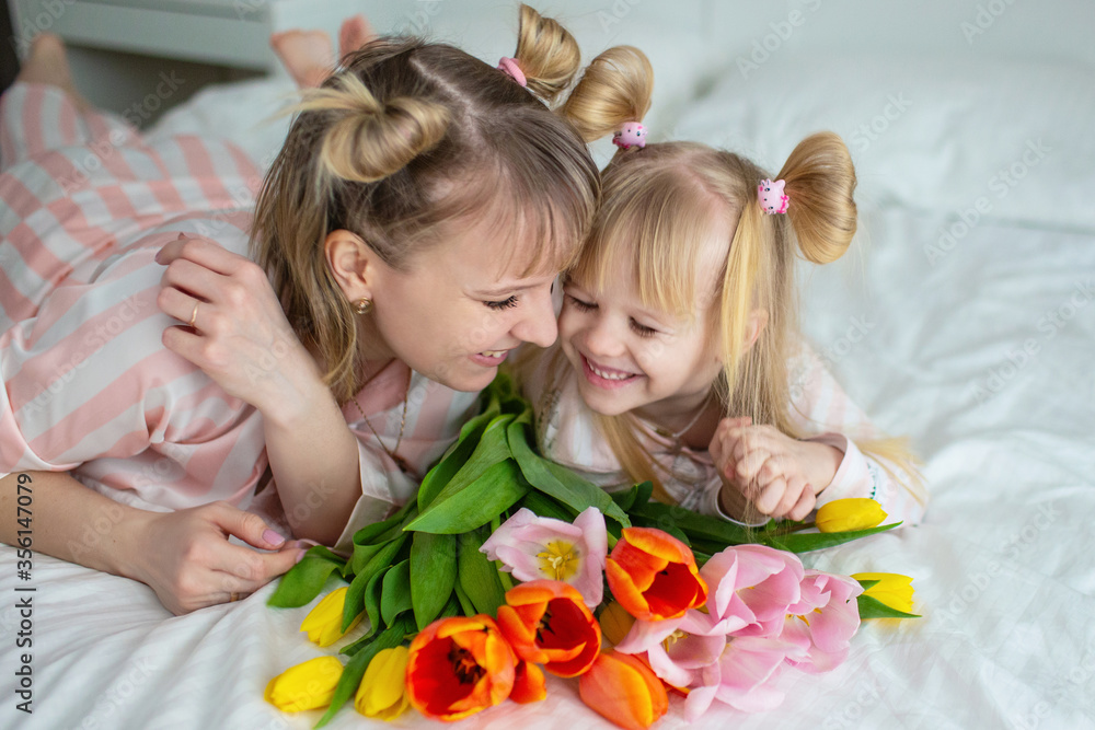 mother with daughter in a white bedroom mother with daughter in a white bedroom