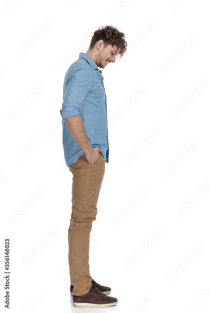 Fototapeta premium happy casual model waiting in line and looking down