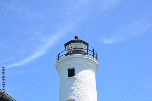tall white lighthouse building and blue sky Tibbetts Point