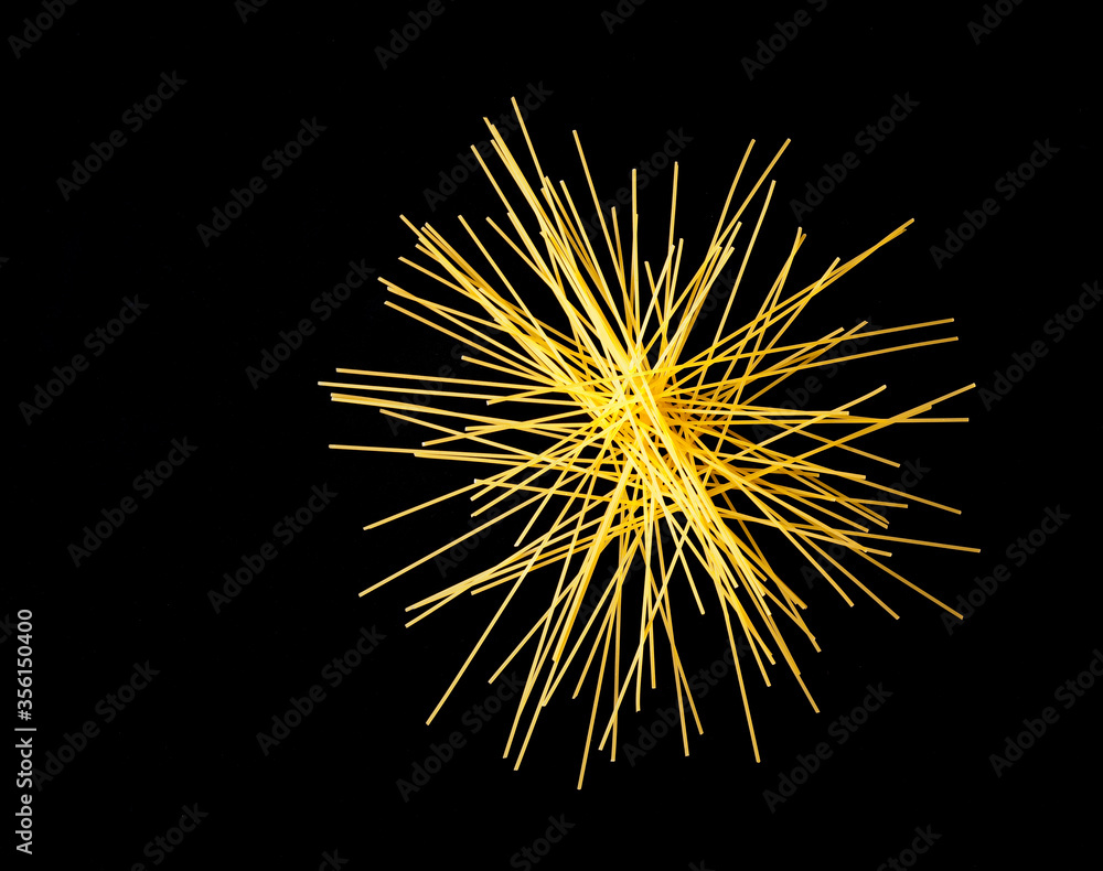 Arrangement of italian Spaghetti on black background, free copy space Arrangement of italian Spaghetti on black background, free copy space