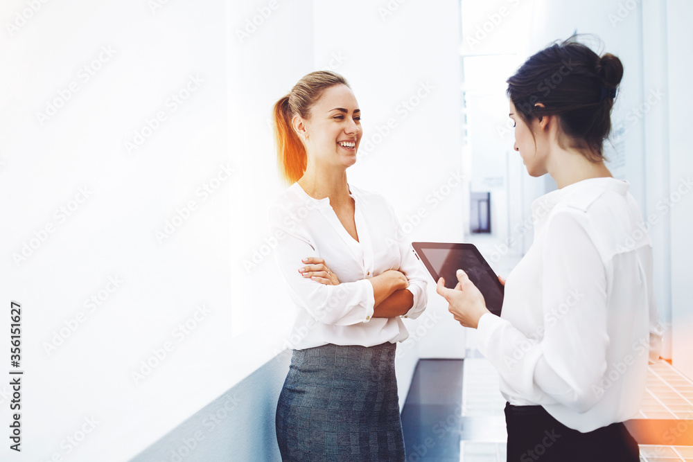 Fototapeta premium Confident businesswoman dressed in corporate clothes posing in hallway of big company