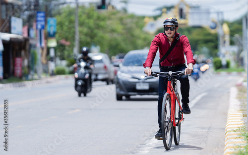 Asian men ride bicycles to work. During a traffic jam © torwaiphoto