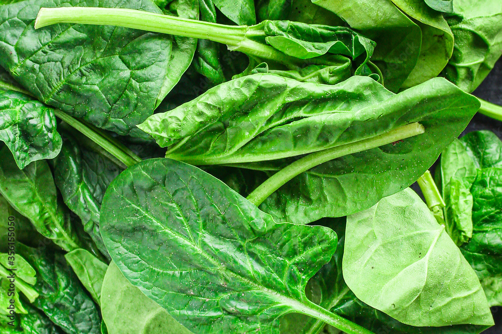 Fototapeta premium spinach green fresh leaves the petals snack vegetables bush green stems and petals Menu concept serving size. food background top view copy space for text keto or paleo diet