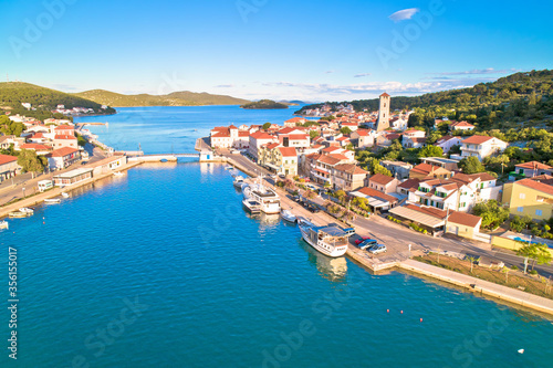 Coastal town of Tisno aerial panoramic view, bridge to island of Murter