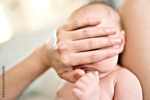 mother hidden baby eye with his hand