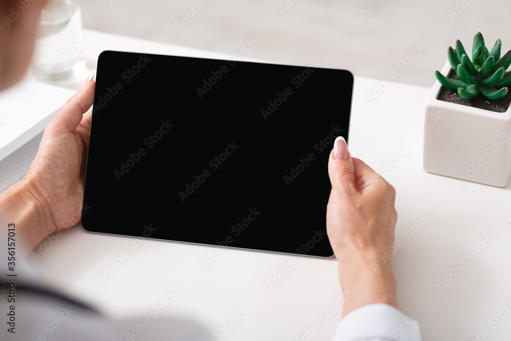 Online doctor and health concept. Woman holds tablet with blank screen Online doctor and health concept. Woman holds tablet with blank screen