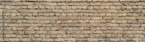 Old vintage yellow brick wall pattern. panoramic view of old brick wall.