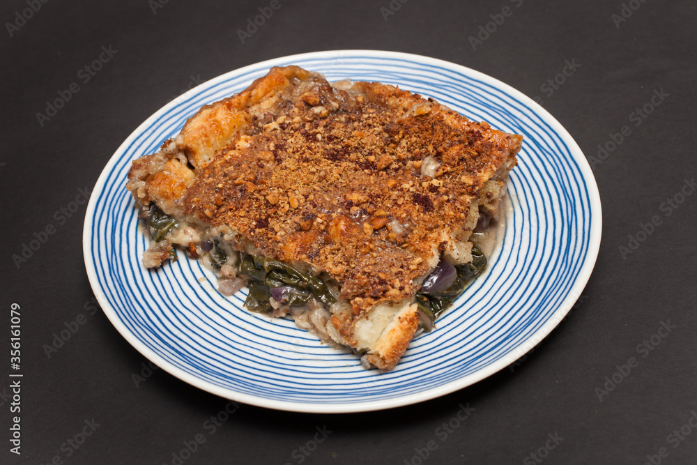 A Piece of Egyptian Spinach Pie with a Dukkah crust topping A Piece of Egyptian Spinach Pie with a Dukkah crust topping
