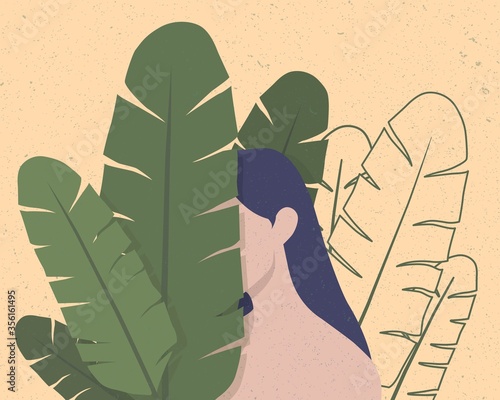 Young girl hiding behind banana leaves covering her face.