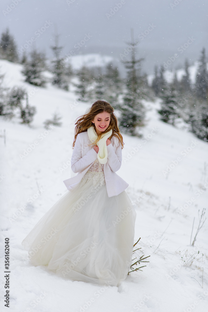 Beautiful bride on a background of a snowy forest. Snowing. Beautiful bride on a background of a snowy forest. Snowing.