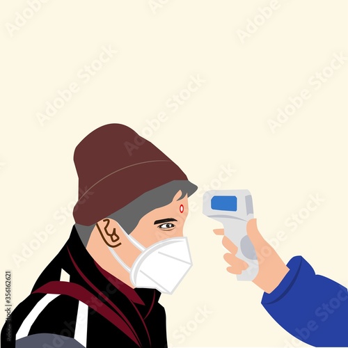 A man checks his body temperature before entering a public area to fight the corona virus