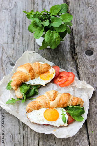 Morning Breakfast with scrambled eggs, croissant and rucola