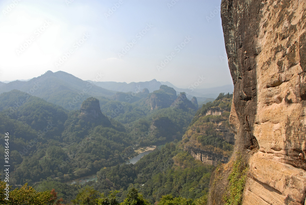 Wuyishan mountains in Fujian Province, China. On the path to DaWang (Great King) Peak. View over the mountains with Nine Bends River or Nine Twists Stream below. Wuyishan is a UNESCO site in China.
