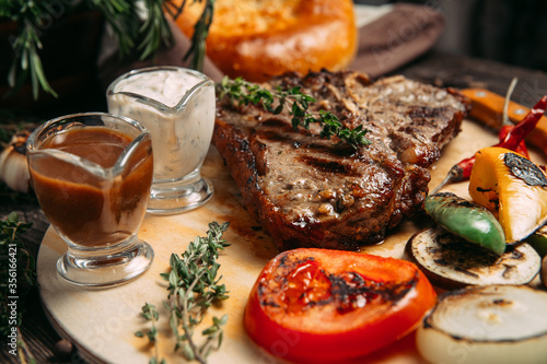 Juicy beef steak with grilled vegetables on board