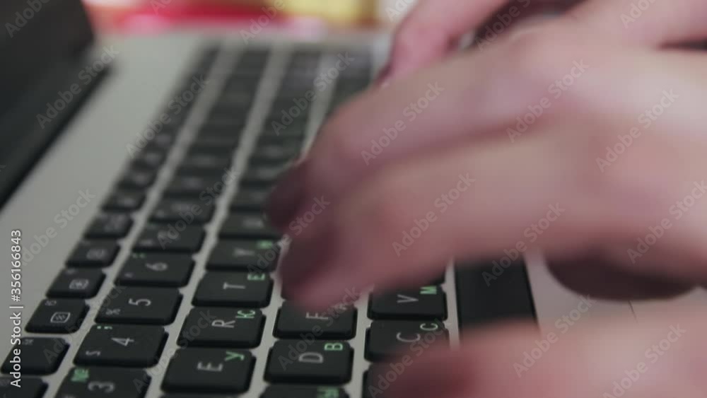 girl typing on a black keyboard of a gray laptop closeup girl typing on a black keyboard of a gray laptop closeup