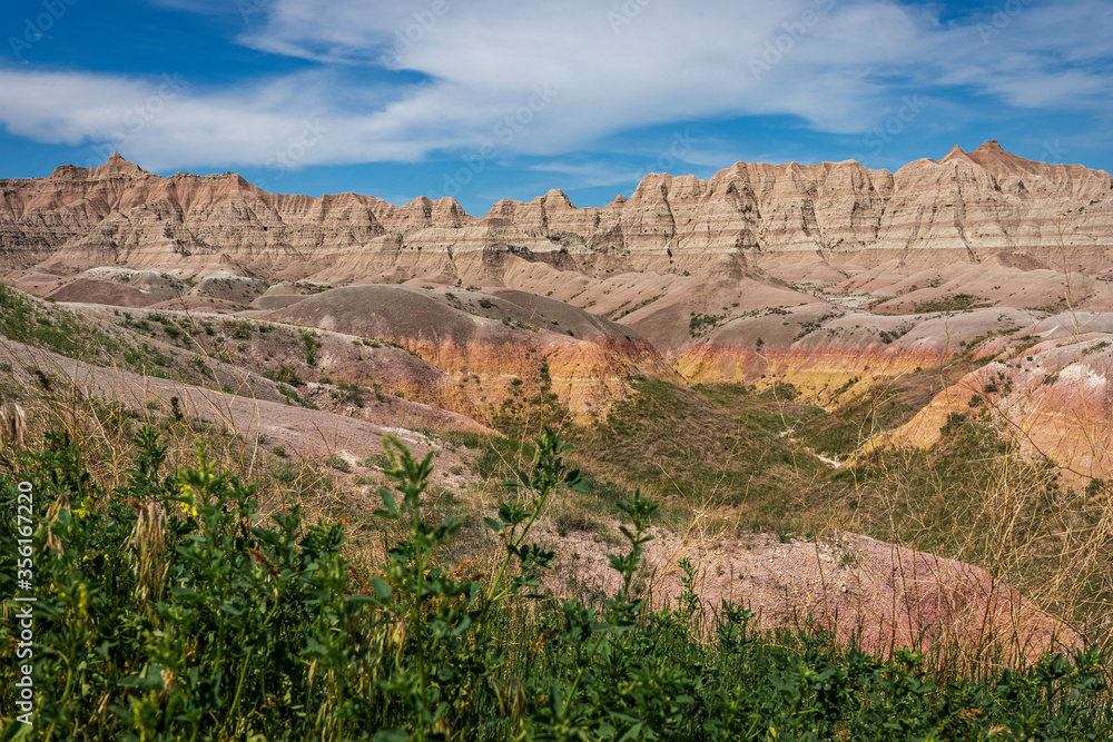 Even in the arid Badlands of South Dakota, colorful rocks and vegetation contrast against the rugged rocks and cliffs.