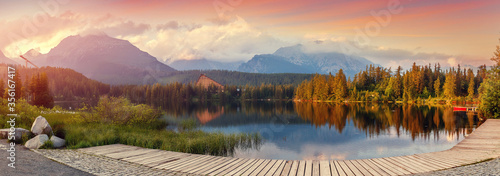 Scenic image of Fairytale lake during sunset. The sunrise over a lake in park High Tatras. Strbske Pleso, Slovakia. Wonderful Autumn landscape. Picturesque view of nature. Amazing natural Background.