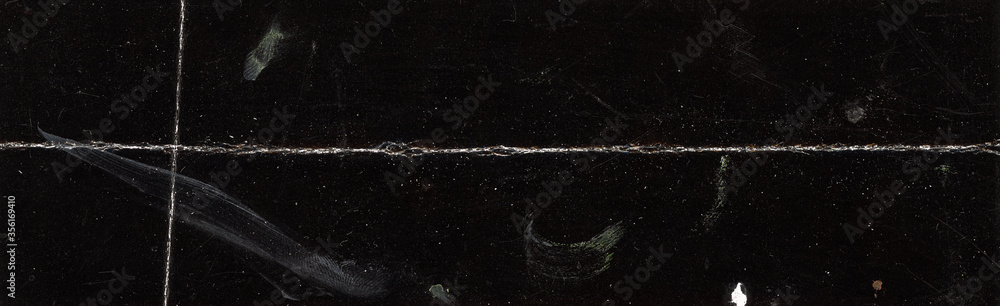 Texture of folded and coated black paper, top view or detail scan.