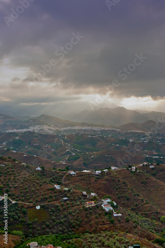 Storm clouds surrounding The Moorish village of Frigiliana nestling in the mountains, Costa del Sol, Andalucia, Spain