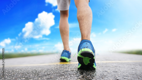 Runner athlete feet running on road. Sport background, workout wellness concept.